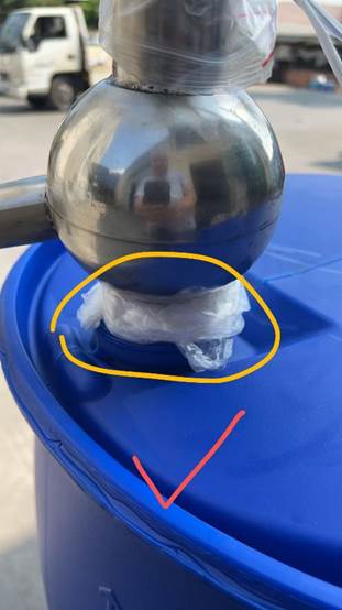A round metal object with a plastic bag on top of a blue trash can
AI-generated content may be incorrect.